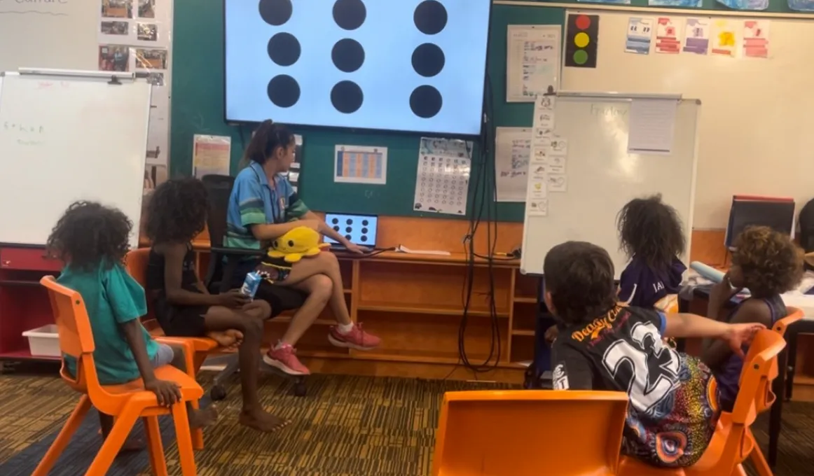 First year primary school teacher Tayha Duggan-Hill with students in Maningrida, NT