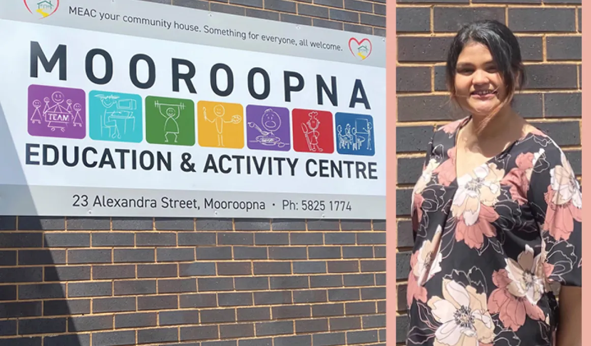 At left is building wall with a large sign featuring the words: Mooroopna Education and Activity Centre. At right is a woman with black hair and wearing a dark dress with large white, yellow and pink flowers.