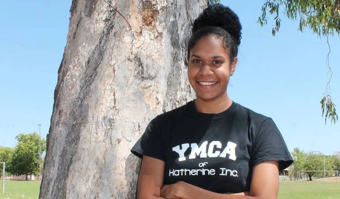 Chantal Ober standing next to tree wearing a YMCA t-shirt