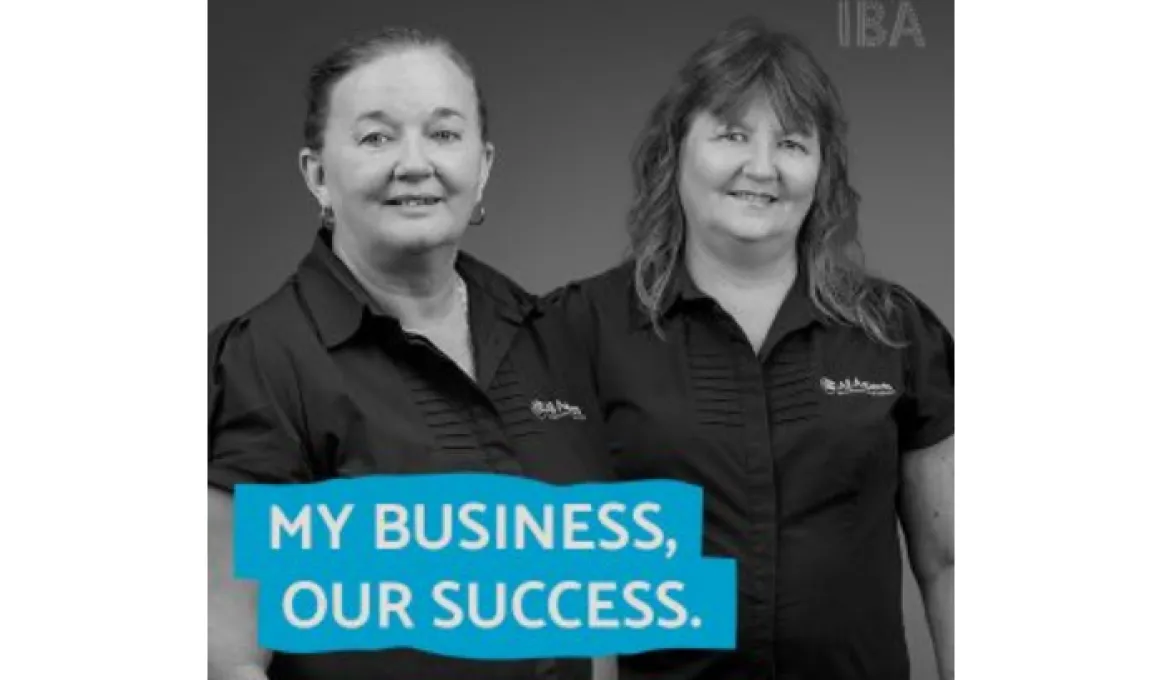 Two women in dark tops stand shoulder to shoulder facing the camera. At the base of the image on a blue background is text: My business, our success.