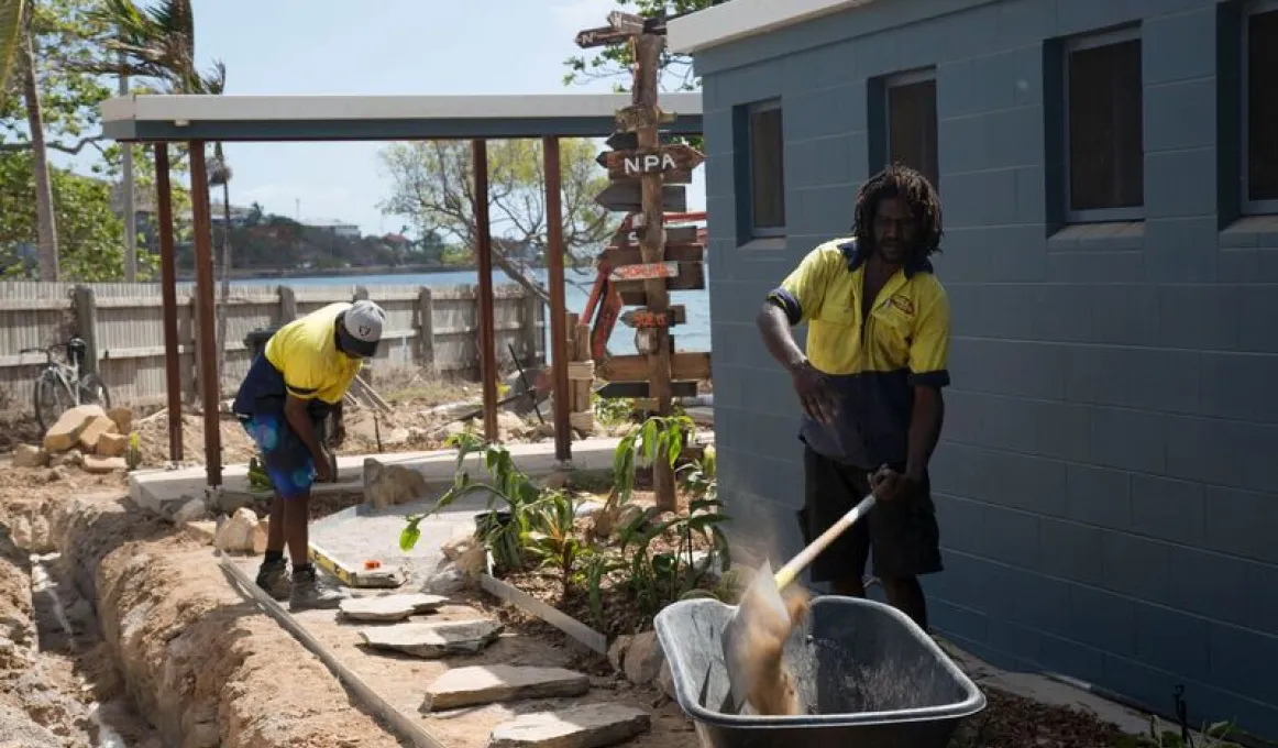 Two Indigenous men working on a landscaping project