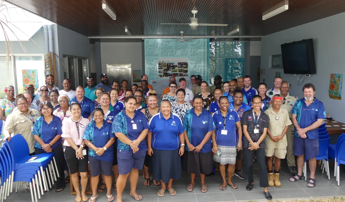 A group of men and women smiling.