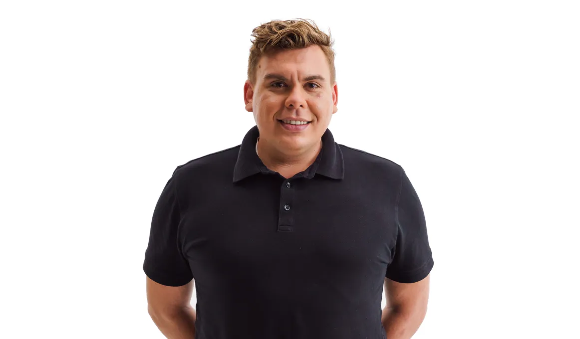 A man in a dark polo shirt faces camera. The background is white.