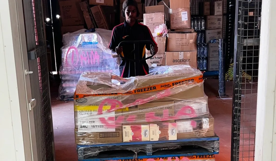 Storeman Lucas Cooper unloading food pallets in the new Freezer servicing Croker Island.