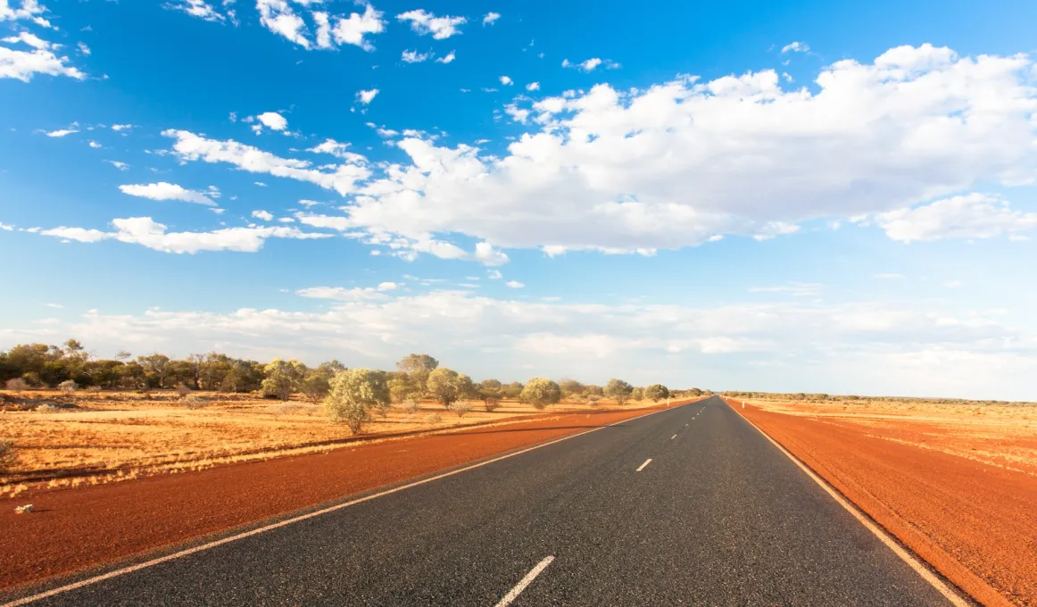 A picture of a highway surrounded by country in Central Australia