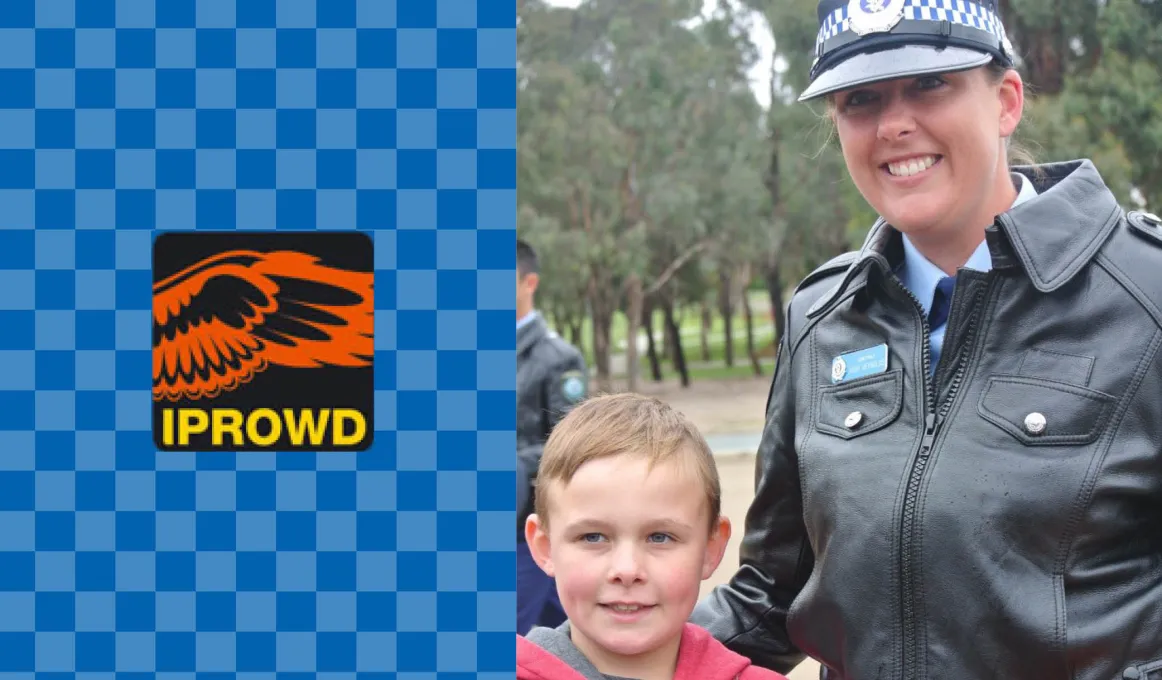 On the left, orange wings on black background with letters IPROWD beneath them all on light and dark blue checked background. On the right, a young boy in red and grey coat stands next to woman in police uniform.