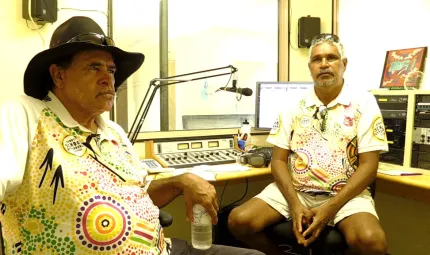 Two Indigenous men in a radio studio.