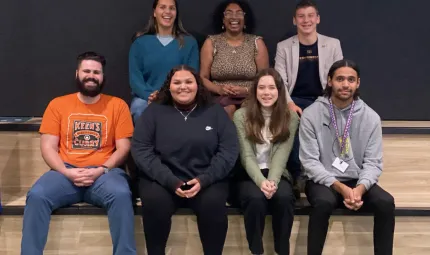 Seven young people sit together smiling - the First Nations Youth Advisory Group