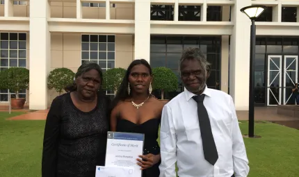 Jericka Mungatopi proudly showing off her award with parents Katrina and Fredrick.