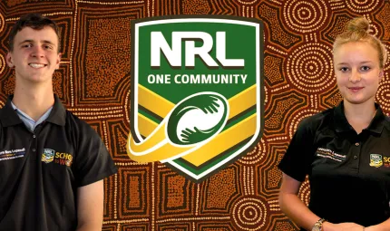 An Indigenous young man and an Indigenous young woman wearing dark polo neck shirts stand each side of a logo which says 'NRL One Community' with an Indigenous design in the background.