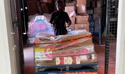 Storeman Lucas Cooper unloading food pallets in the new Freezer servicing Croker Island.