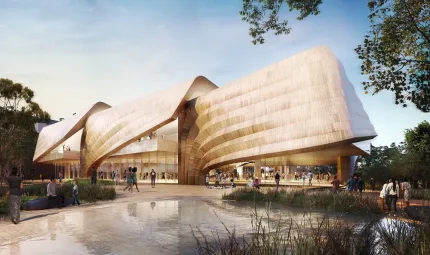 A building with three cantilevered and ribbed rooves sits in the background. In the foreground is a pond with reeds and a number of people walking near and under the building.