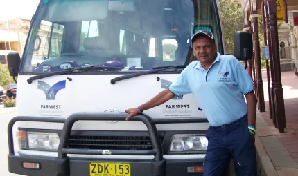 Terry Doolan standing in front of his bus.