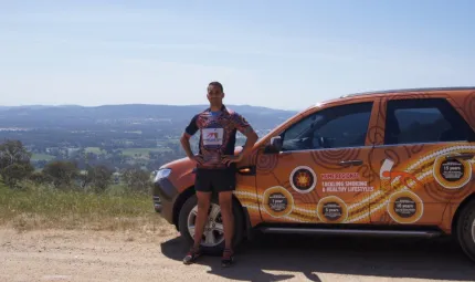 Tobacco Action Worker Jethro Calma-Holt in front of his work vehicle