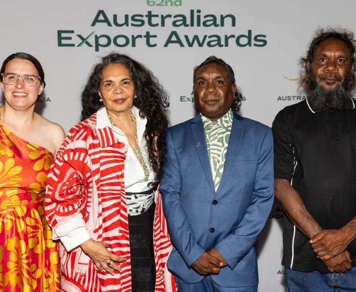 4 people stand in front of the Australian Export Awards