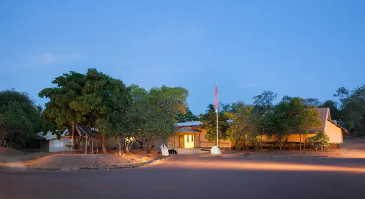 Buku-Larrnggay Mulka Centre sitting among trees with flag in front.