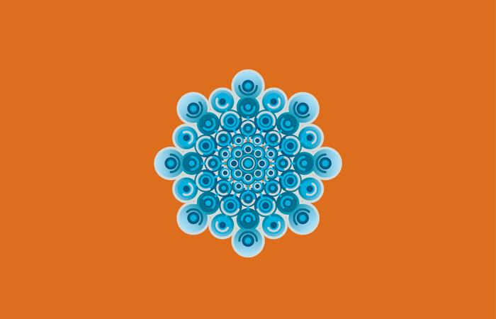 A selection of blue dots in varying shade of blue in the shape of a snowflake on an orange background.