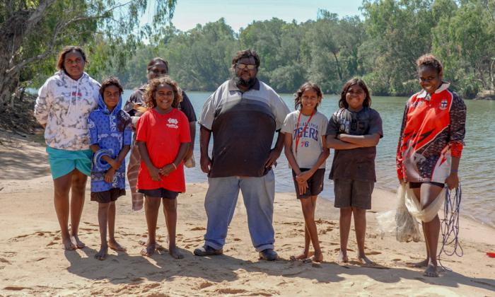 Eight people standing on the beach