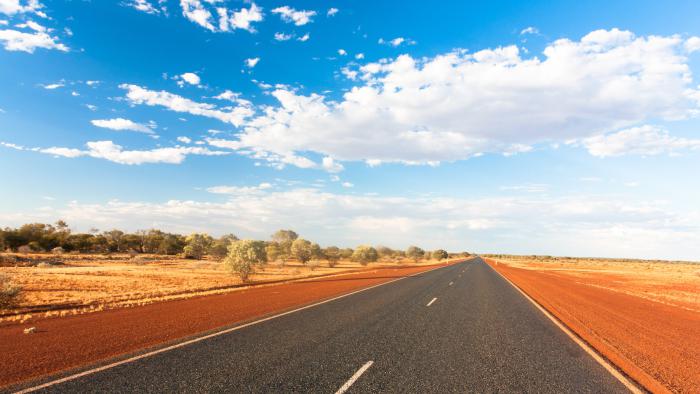 A picture of a highway surrounded by country in Central Australia