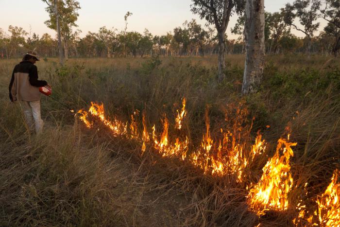Larbagayan traditional owner Darren Sambono carrying out a controlled cool season burn on Fish River, NT.