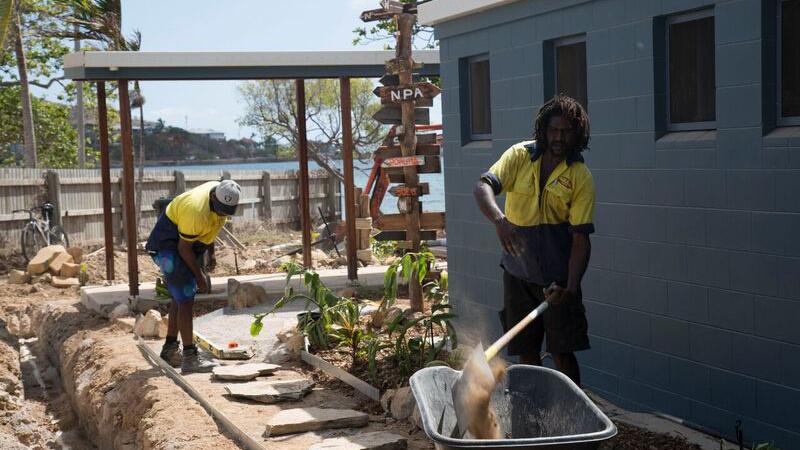 Two Indigenous men working on a landscaping project