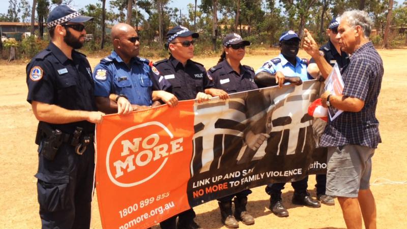 NO MORE campaign founder Charlie King with local police and visiting PNG police at the NO MORE launch in Ramingining 