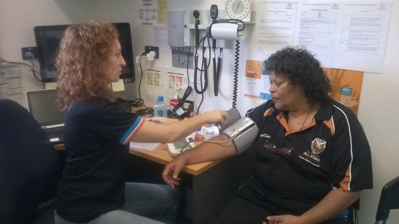 Woman inspecting health of another woman in a surgery.