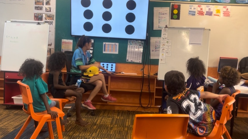 First year primary school teacher Tayha Duggan-Hill with students in Maningrida, NT