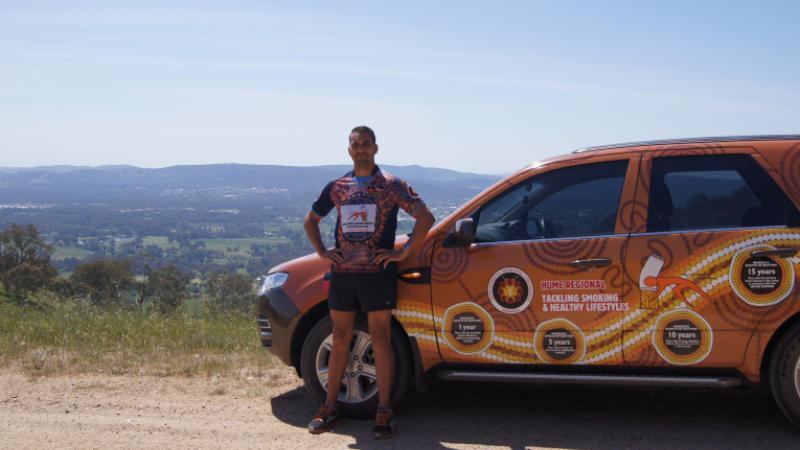 Tobacco Action Worker Jethro Calma-Holt in front of his work vehicle