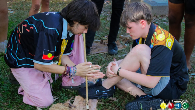 Yankunytjatjara student, Jack Tur-Martens (left) and Ngarrindjeri student, Joshua West, working together to light a fire at the Culture Night.