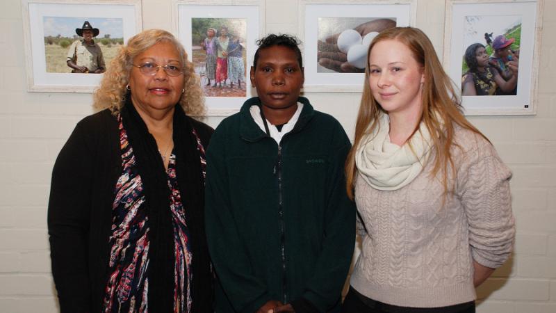 Chrissy Grant, Wanggawuy "Grace" Mununggurritj and Amy Rayner with some of the Working on Country Exhibition photos