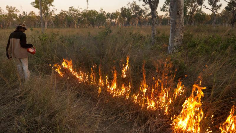 Larbagayan traditional owner Darren Sambono carrying out a controlled cool season burn on Fish River, NT.